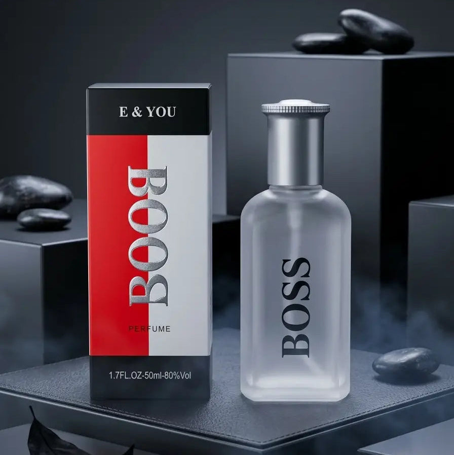 BOSS BOOSTYLE E & YOU perfume bottle and packaging box displayed on a dark gray pedestal with black stones in the background.